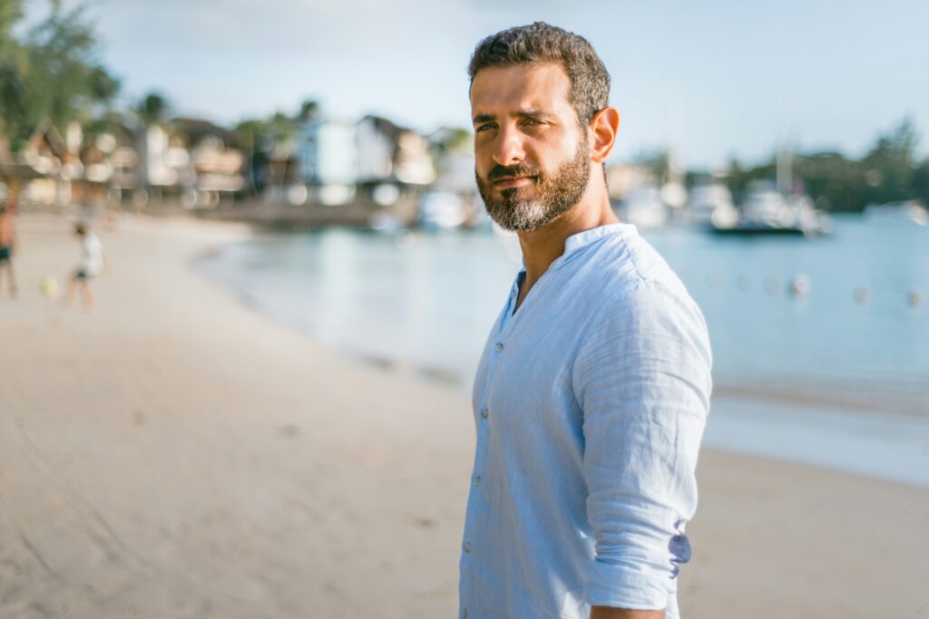 serious man walking along beach